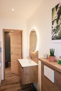 a bathroom with a sink and a mirror at En plein centre du village ! in Villard-de-Lans +46 photos