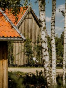 an old wooden building with an orange roof at Drewniana Osada in Gołdap +36 photos