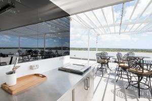 a kitchen and dining area on a boat with tables and chairs at Riviera Mackay in Mackay