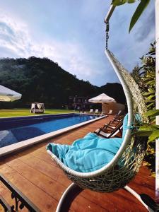 a hammock on a deck next to a swimming pool at Apartments Djurovic in Virpazar