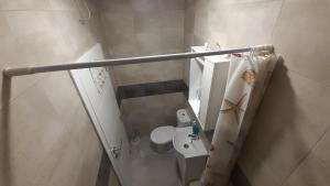 a small bathroom with a toilet and a sink at Soba Za Odmor # in Mladenovac +9 photos