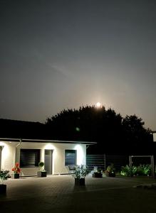 a house at night with the moon in the sky at A7 Apartment 1 in Dätgen