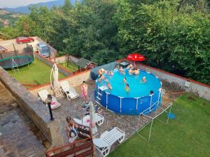 an overhead view of a swimming pool with people in it at Family Hotel Diana in Lyaskovo