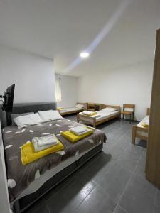 a bedroom with a large bed with yellow towels on it at Vile Jana in Leskovac