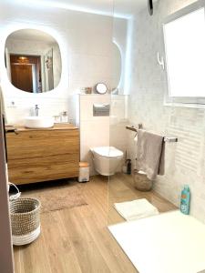 a bathroom with a toilet and a sink and a mirror at Casa Boho in Cumbre del Sol