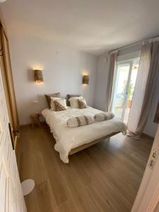 a bedroom with a large bed and a large window at Casa Boho in Cumbre del Sol