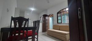 a living room with a table and a couch at Sua casa longe de casa in Mongaguá