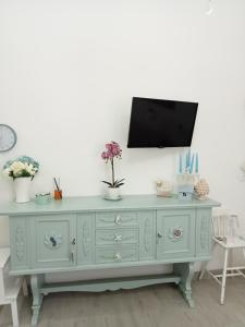 a blue dresser with a tv on top of it at La casa di Lilia in Francavilla al Mare