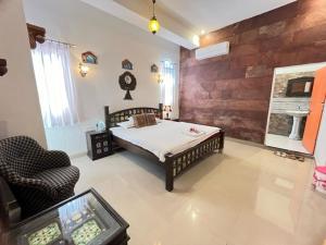a bedroom with a bed and a chair in a room at Karma homestay in Jodhpur