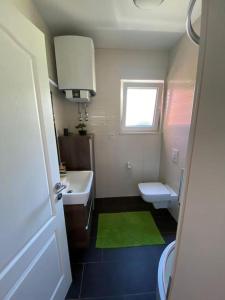 a bathroom with a sink and a toilet and a window at Oleander in Podstrana +45 photos