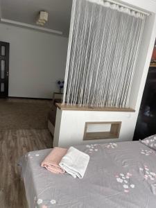 a bedroom with a bed with a large window at Уютная квартира in Chişinău