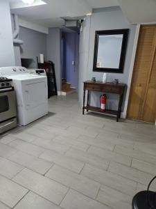 a kitchen with a stove and a white floor at Pizzo Cozy Hideout in Toms River
