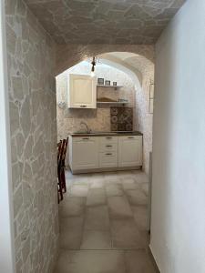 a kitchen with an archway in a stone wall at Ercolano Civitas in Ercolano +2 photos