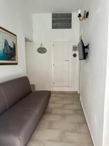 a living room with a couch and a television at Ercolano Civitas in Ercolano