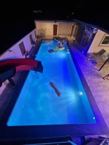 an overhead view of a swimming pool at night at Huahin Friends Pool Villa 1 in Hua Hin
