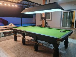 a pool table in the middle of a room at Huahin Friends Pool Villa 1 in Hua Hin
