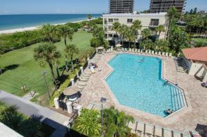 an overhead view of a swimming pool and the beach at Land's End 8-301 Beach Front in St. Pete Beach