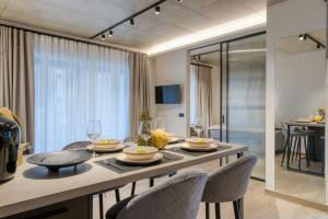 a kitchen and dining room with a table and chairs at Amphora Nafplio- elegance Suites Apartmenthouse in Nafplio