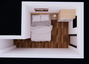 a small bedroom with a bed in a small room at Sơn Trang House in Sa Pa