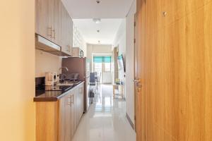 a kitchen with wooden cabinets and a counter top at J5 Bayview Elegant Retreat with Stunning Views Free WiFi in Manila