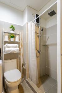 a bathroom with a toilet and a shower at J5 Bayview Elegant Retreat with Stunning Views Free WiFi in Manila