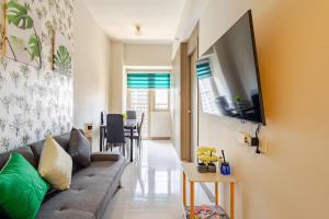 a living room with a couch and a table at J5 Bayview Elegant Retreat with Stunning Views Free WiFi in Manila