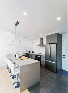 a kitchen with a counter and a refrigerator at LuxQuarters Huckleberry Suite in Kitimat