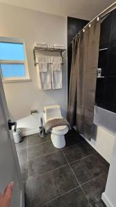 a bathroom with a toilet and a shower at LuxQuarters Huckleberry Suite in Kitimat +14 photos
