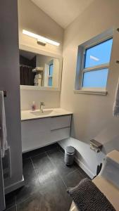 a bathroom with a sink and a mirror at LuxQuarters Huckleberry Suite in Kitimat
