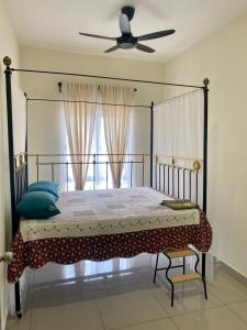 a bedroom with a bed with a fan and a window at Tiny Sweet Home in Kajang +15 photos
