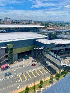 a large building with a parking lot in front of it at Tiny Sweet Home in Kajang