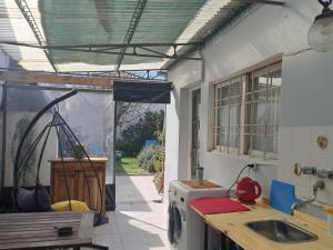a kitchen with a sink and a washing machine at El cerezo in Tandil