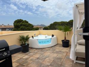 a hot tub on the balcony of a house at Apt Kandinsky Mallorca in S'Illot