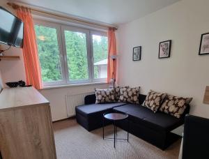 a living room with a couch and a table at Jasna 96 in Belá