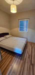 a bedroom with a bed in a room with a window at EA1 Jablaničko jezero in Konjic