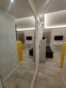 a hallway with a mirror and a living room at Luxury Apartments Riva Vena in Chioggia +60 photos