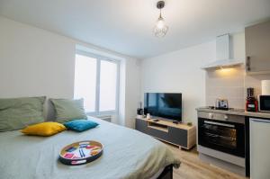a bedroom with a bed with a tray of food on it at Le Cocoon, studio centre, wifi, stationnement in Cognac +14 photos