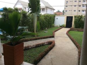 a garden with a potted plant and a walkway at Guest Wharf in Pointe-Noire