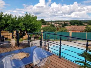 a view from the balcony of a house with a swimming pool at Villa Palmera - Classée 3 étoiles - Grand confort, calme, et magnifique vue dégagée in Canet