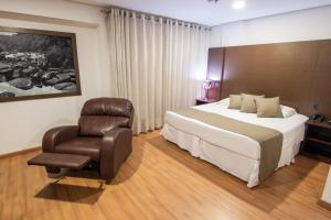 Postel nebo postele na pokoji v ubytování Olavo Bilac Hotel