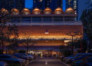 a building with cars parked in a parking lot at Alma House in Singapore