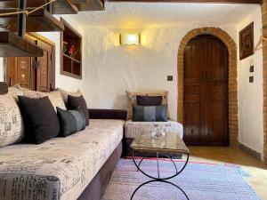 a living room with a couch and a table at Riad Gharnata in Chefchaouen