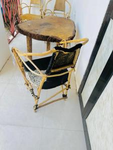 a table and a chair with a wooden table and a table and a table at paje zanzibar apartment in Paje +19 photos
