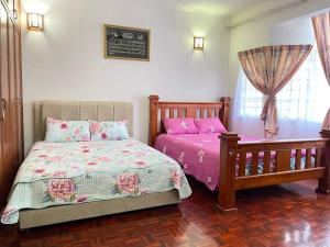 Giường trong phòng chung tại 4BR 2Storey Terrace Homestay at Bukit Jambul by SK Vacation Homes