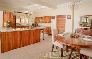 a kitchen with wooden cabinets and a wooden table at Leaves Lodge and Spa in Nelspruit