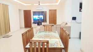 a dining room and living room with a table and chairs at BJ Villa in Mohali