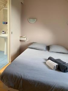 a bedroom with a bed with two towels on it at Charme St Malo in Saint Malo