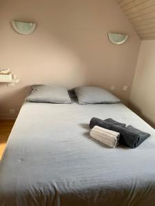 a bedroom with a bed with two towels on it at Charme St Malo in Saint Malo +6 photos