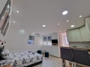 a bedroom with a bed and a table and chairs at Zed Apartments in Leskovac