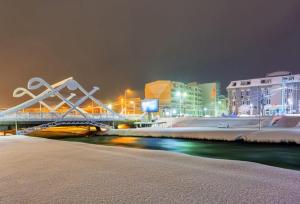 a bridge over a river in a city at night at A2 Apartment in Gostivar